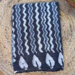 Elegant Jaipur cotton saree in classic black with white patterns, offering comfort, breathability, and timeless ethnic charm.